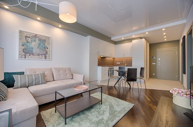 Living room with white couch and dining table